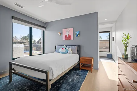 a bedroom with a large bed and a large window