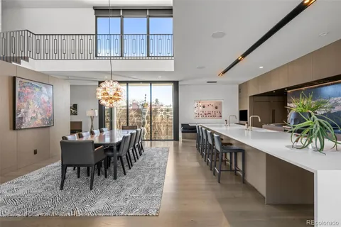 a dining room with furniture a rug and a large window