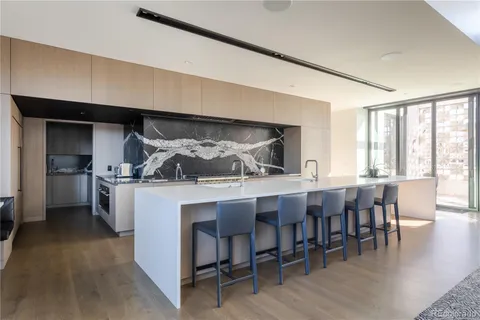 a kitchen with a table chairs stove and cabinets