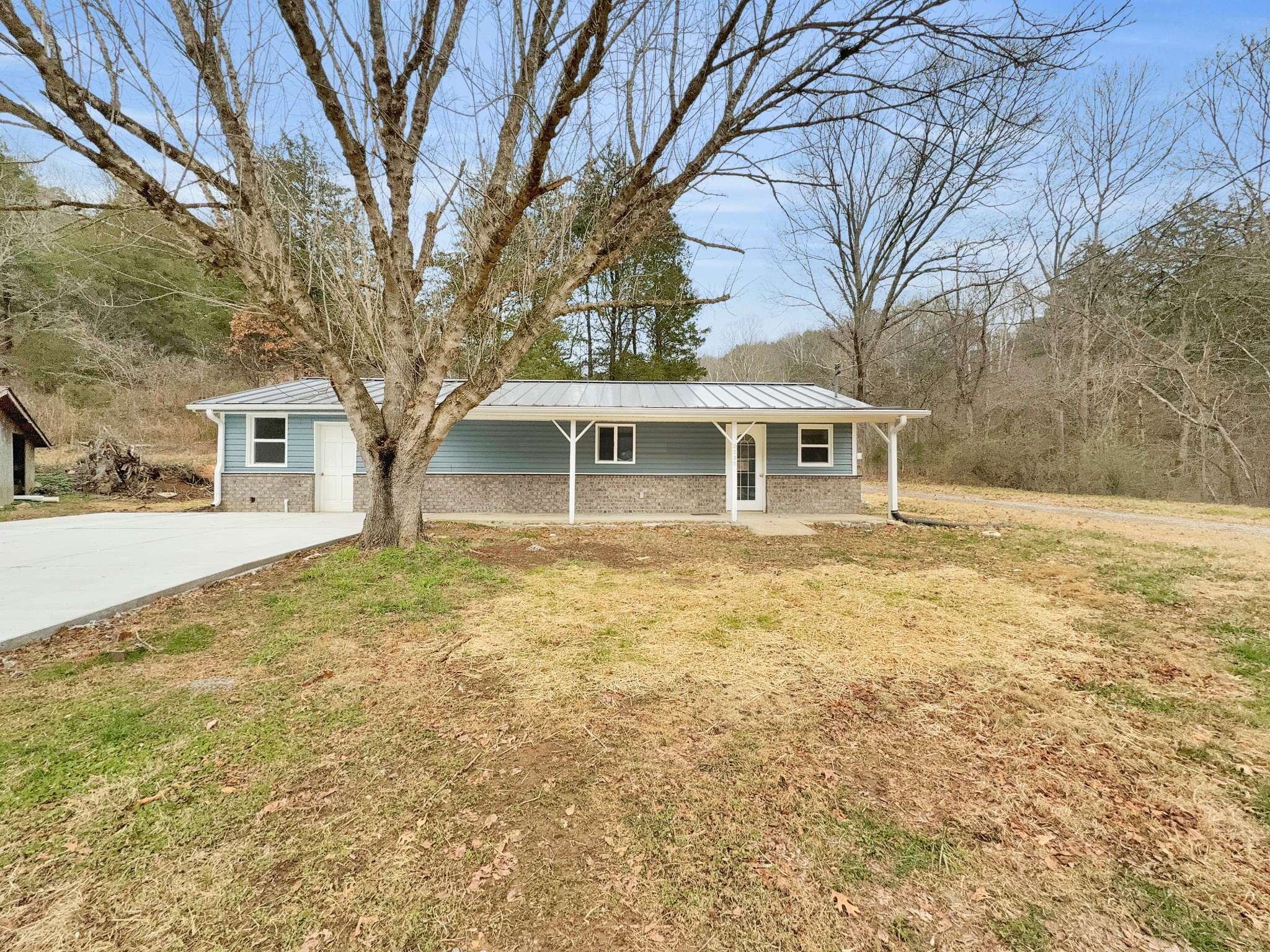 3337 Hartsville Road Lafayette, TN 37083 - Photo 1 of 17 a house with trees in front of it