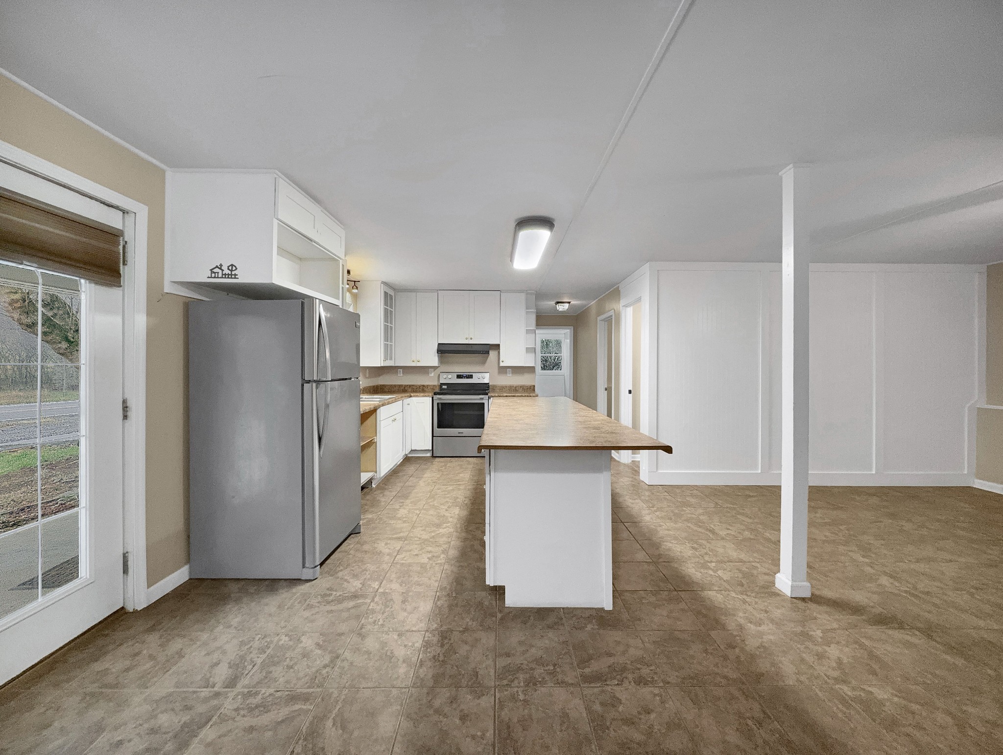 3337 Hartsville Road Lafayette, TN 37083 - Photo 8 of 17 a kitchen with stainless steel appliances a refrigerator sink and white cabinets
