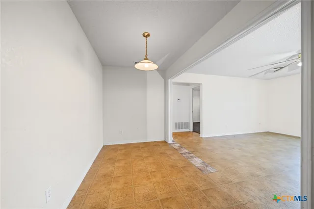 a large kitchen with a large window and stainless steel appliances