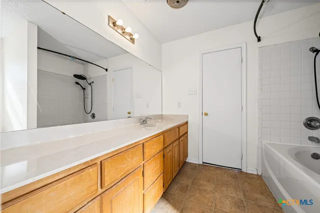 an empty room with fan and windows