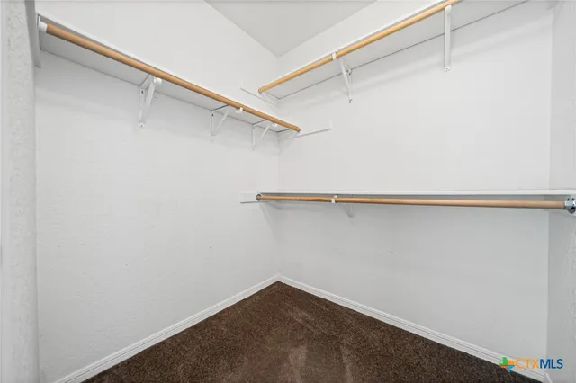 an empty room with a ceiling fan and a window