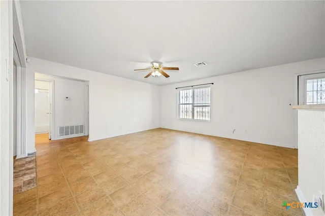 a view of a room with window and ceiling fan