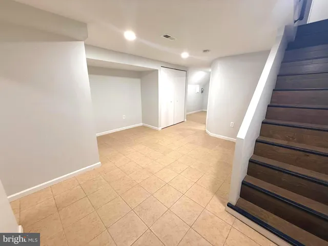 a view of an empty room with stairs