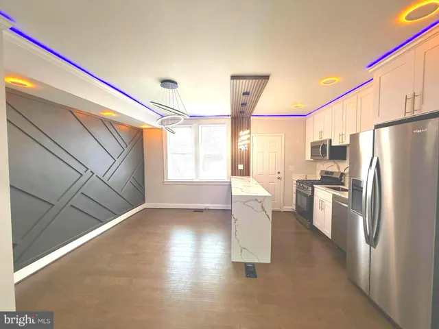 a kitchen with stainless steel appliances a refrigerator and a stove