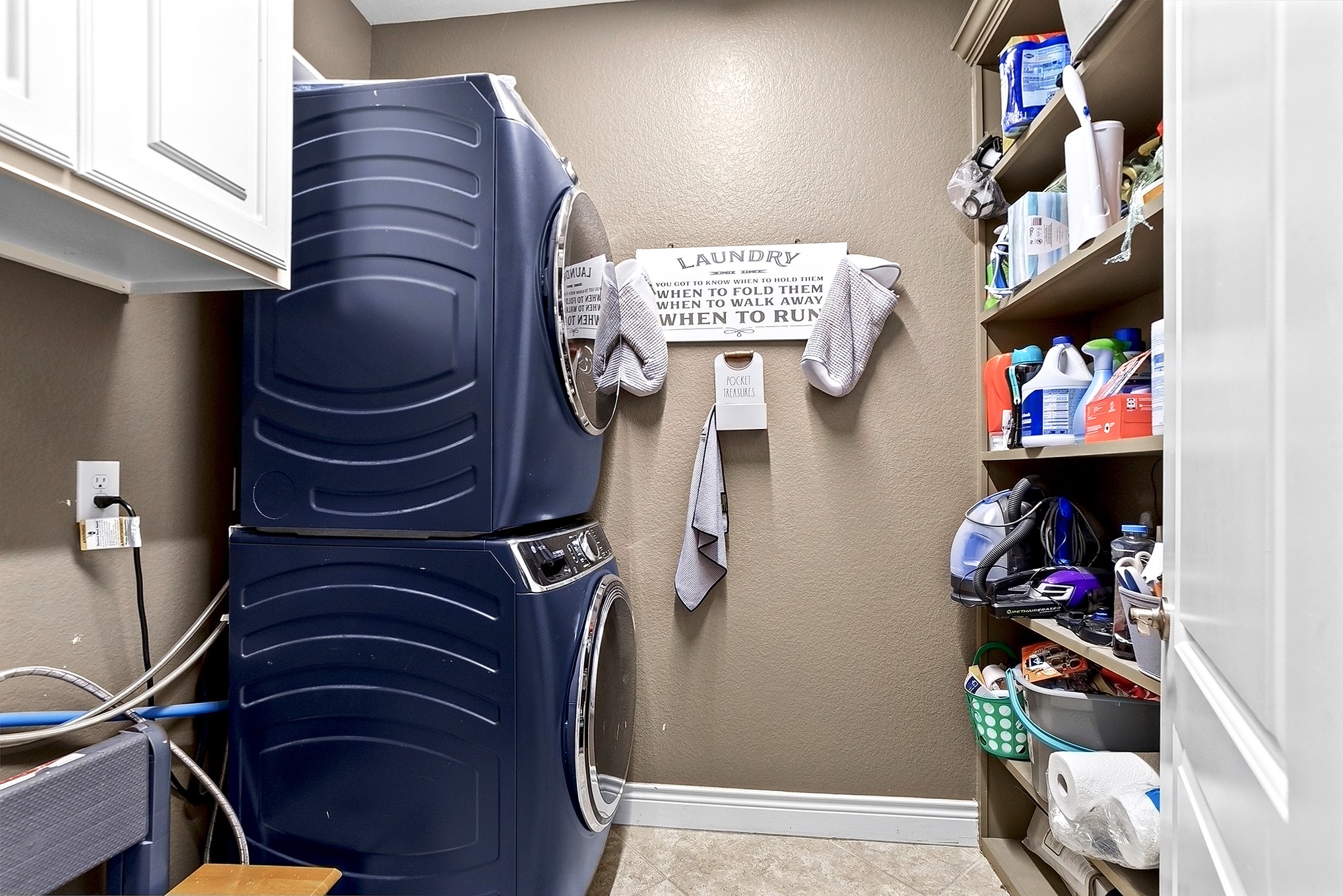 2951 Bobby Jones Road Katy, TX 77494 - Photo 45 of 50 The large utility room features a full wall of built-in shelving for extra storage. Cabinetry, providing plenty of space to keep everything organized and easily accessible.