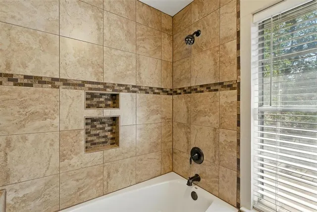 a bathroom with a shower and a bathtub