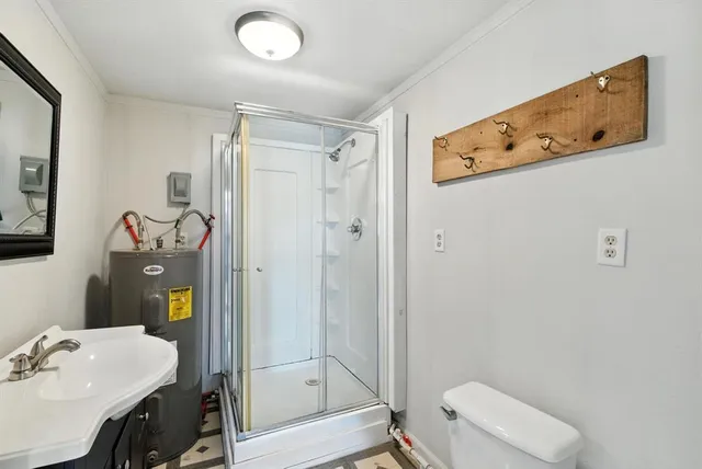 a bathroom with a shower a sink and a mirror