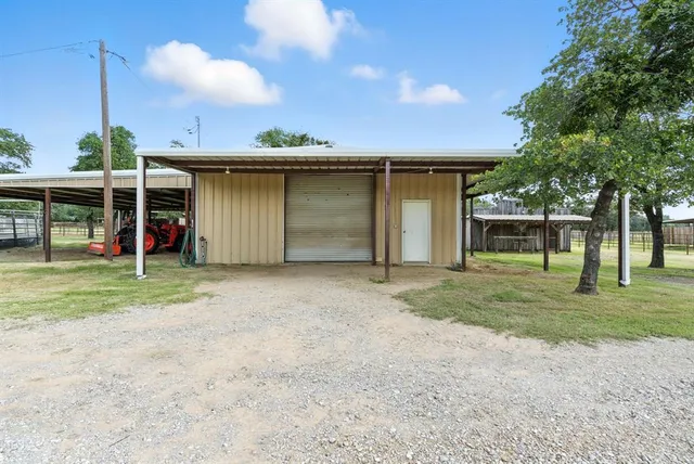 a view of a house with a backyard and a garage