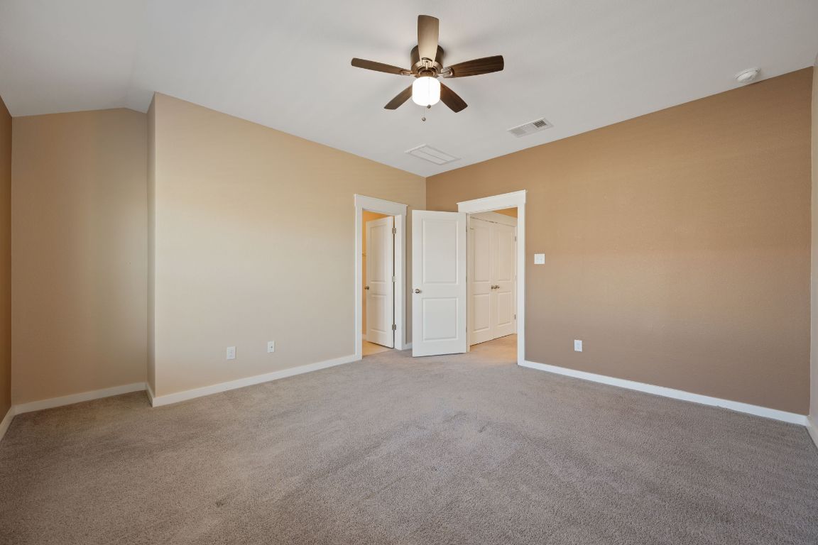 602 Knopper Street, Unit B Pflugerville, TX 78660 - Photo 14 of 26 Unfurnished bedroom featuring light colored carpet and a ceiling fan