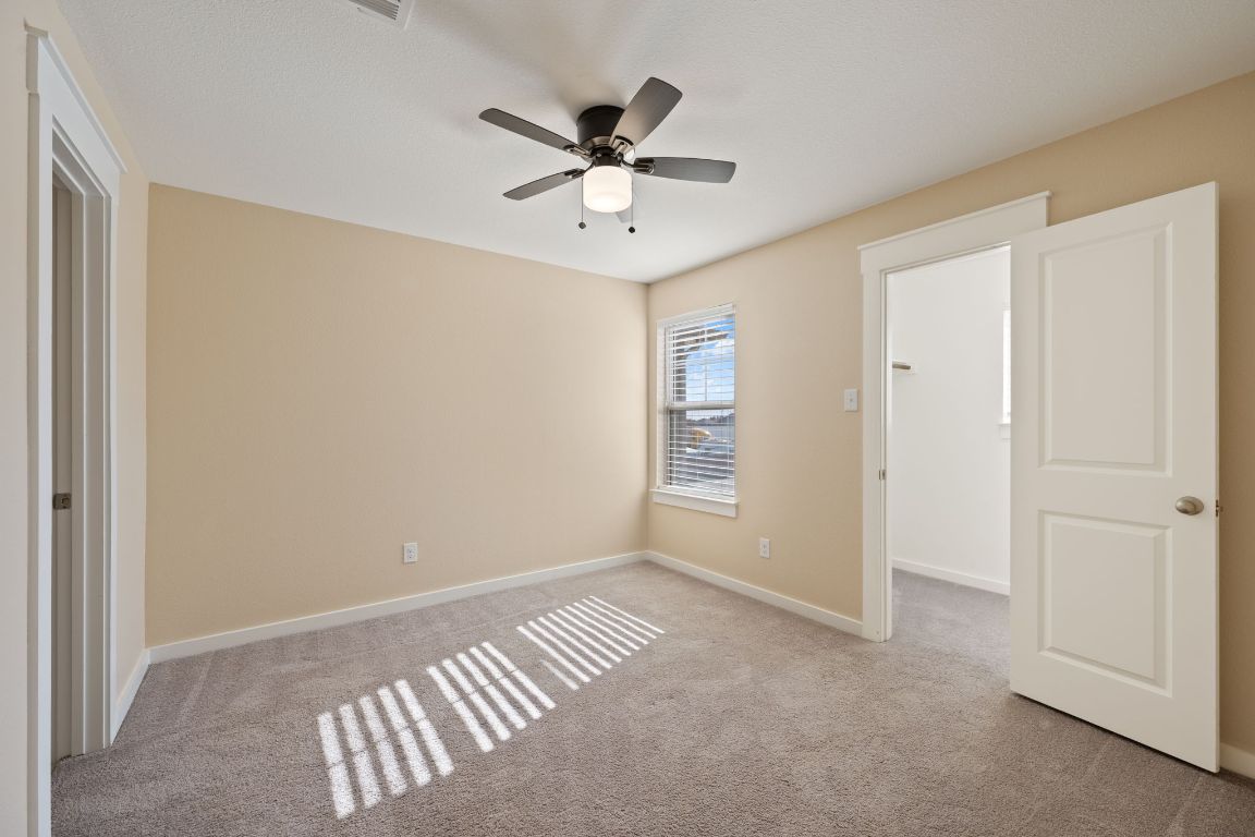 602 Knopper Street, Unit B Pflugerville, TX 78660 - Photo 18 of 26 Unfurnished bedroom with carpet floors and a ceiling fan