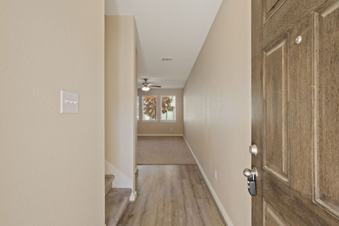 602 Knopper Street, Unit B Pflugerville, TX 78660 - Photo 2 of 26 Hallway featuring light wood-style flooring and stairway