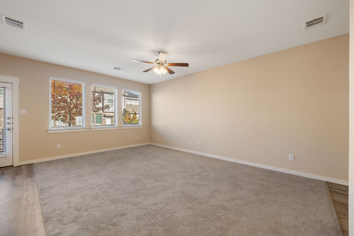 602 Knopper Street, Unit B Pflugerville, TX 78660 - Photo 4 of 26 Unfurnished room with light wood-style flooring and ceiling fan