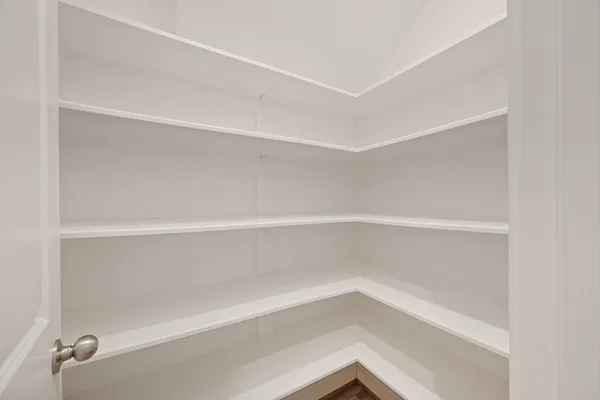 a kitchen with a sink cabinets and wooden floor