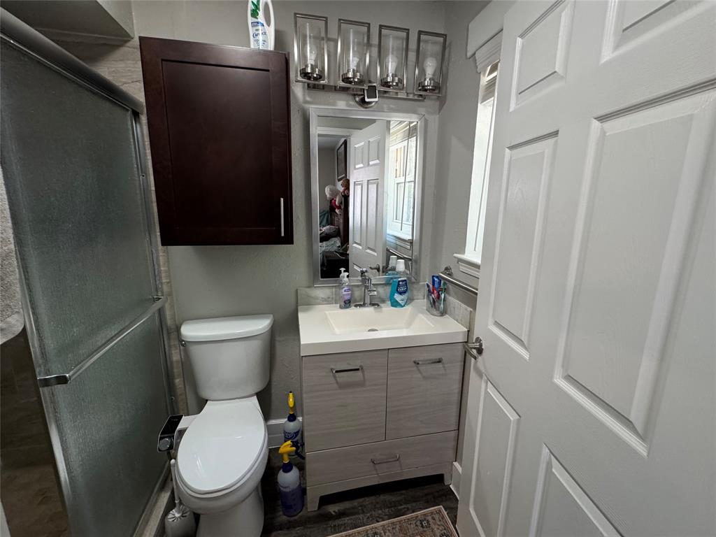 320 Pecan Street Wilmer, TX 75172 - Photo 16 of 25 Bathroom featuring vanity and a shower stall