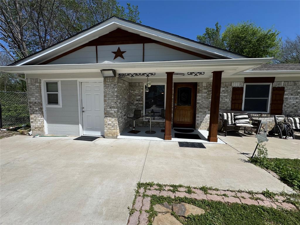 320 Pecan Street Wilmer, TX 75172 - Photo 2 of 25 View of front of home featuring covered porch and brick siding