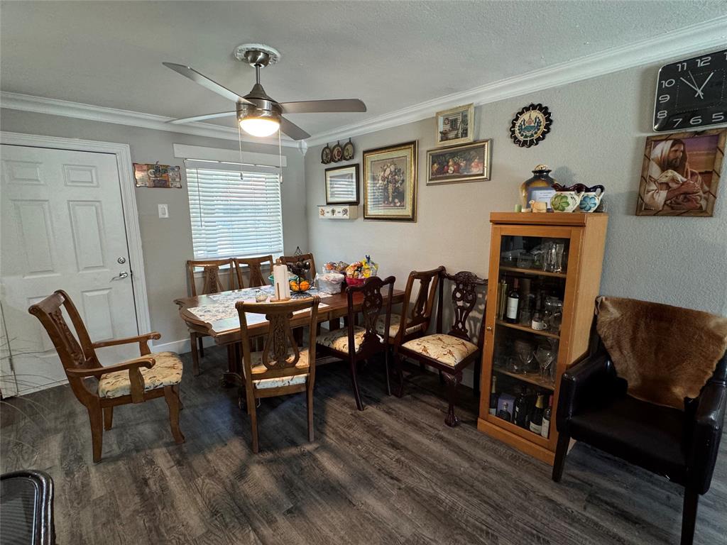 320 Pecan Street Wilmer, TX 75172 - Photo 5 of 25 Dining area with crown molding, wood finished floors, and a ceiling fan