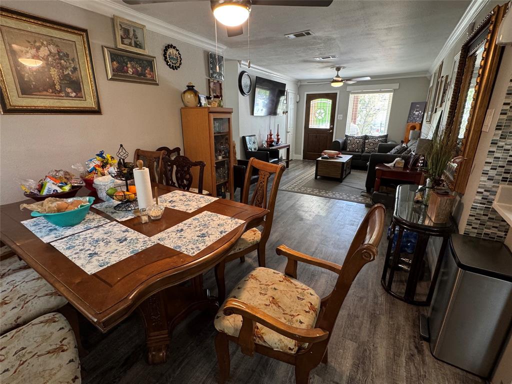 320 Pecan Street Wilmer, TX 75172 - Photo 6 of 25 Dining area featuring dark wood-style flooring, ornamental molding, and a ceiling fan