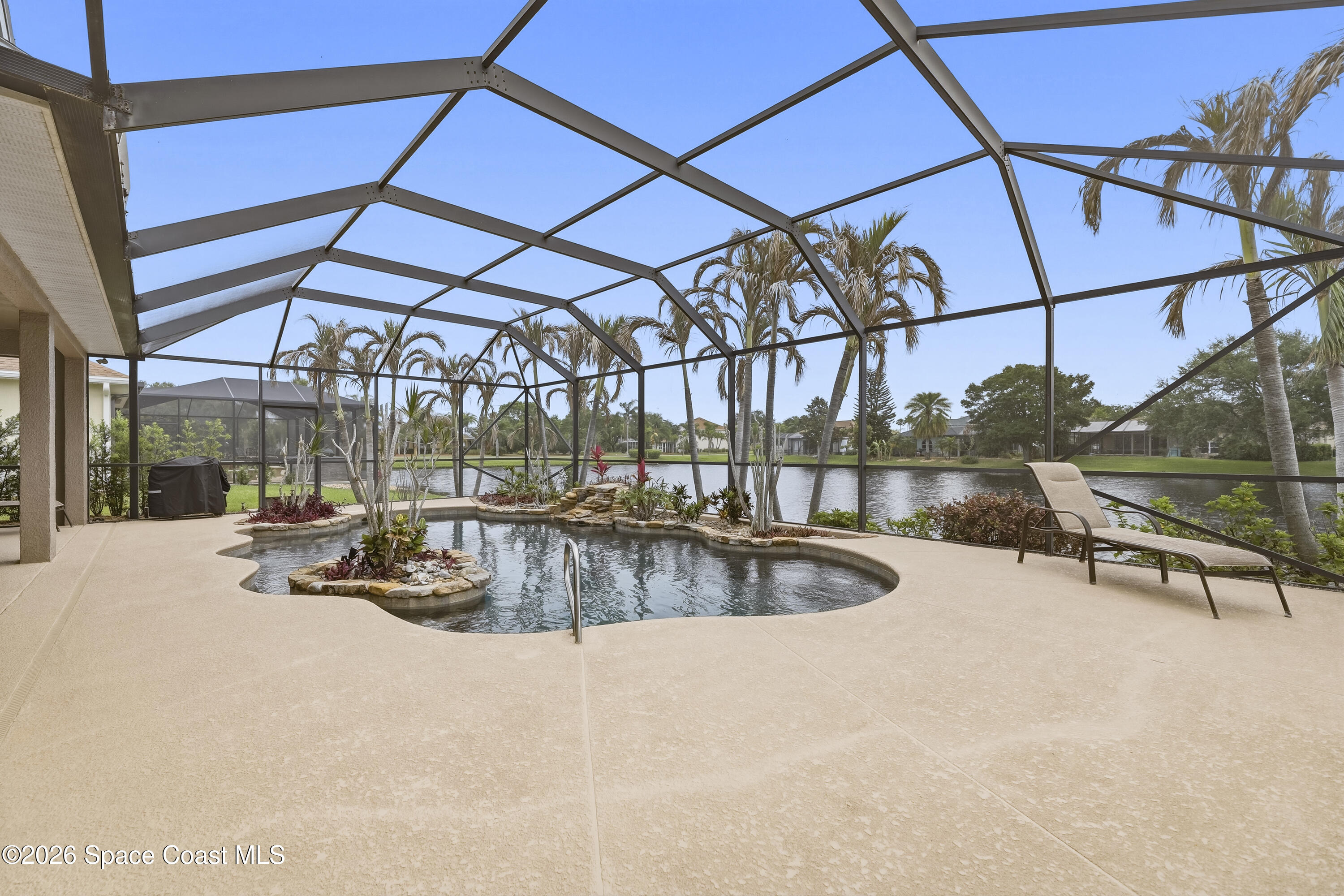 1643 Long Pine Road Melbourne, FL 32940 - Photo 49 of 63 a view of a swimming pool with a patio and a yard