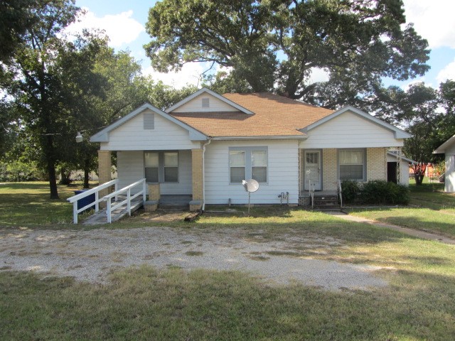 a view of a house with a yard and sitting area