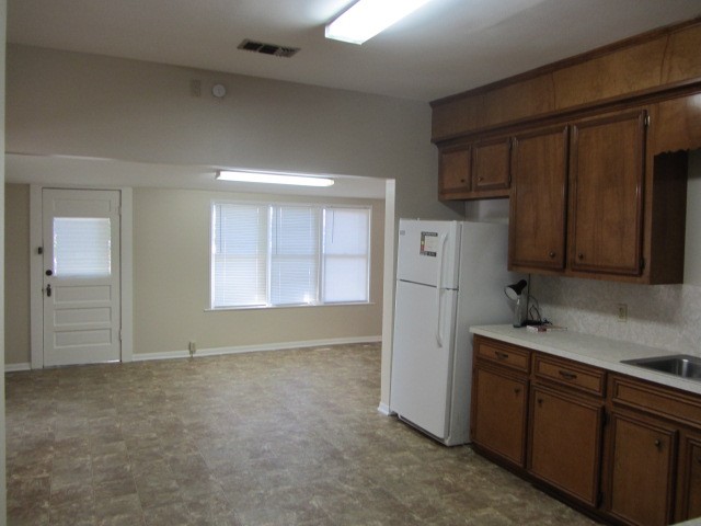 3002 Montgomery Road Huntsville, TX 77340 - Photo 15 of 27 a kitchen with cabinets and a refrigerator