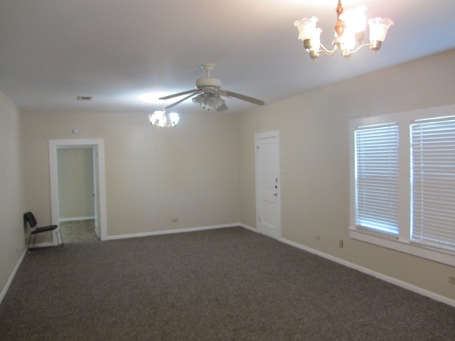 3002 Montgomery Road Huntsville, TX 77340 - Photo 16 of 27 en empty room with windows and ceiling fan