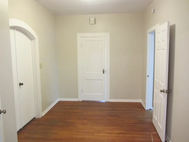 a view of a room with wooden floor and closet