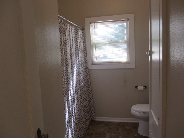 3002 Montgomery Road Huntsville, TX 77340 - Photo 7 of 27 a bathroom with a toilet and a shower