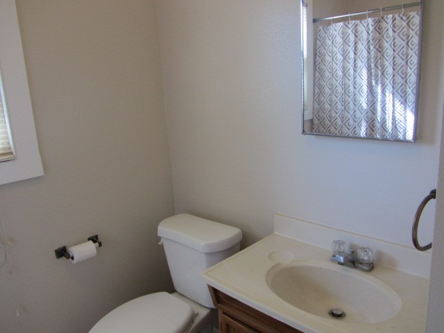 3002 Montgomery Road Huntsville, TX 77340 - Photo 8 of 27 a white toilet sitting next to a bathroom sink