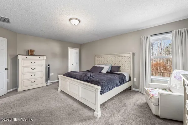 a bedroom with a bed and a couch