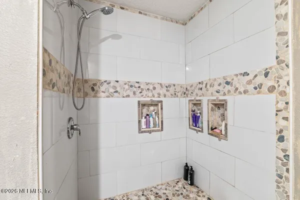 a bathroom with a shower and a sink