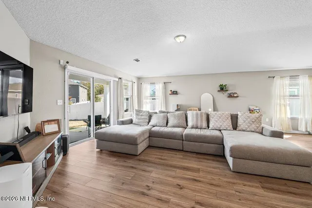 a living room with furniture and a wooden floor