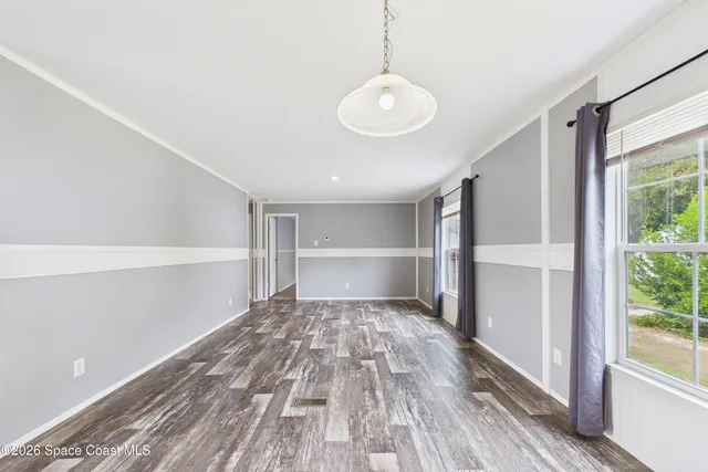 a view of a room with wooden floor and window