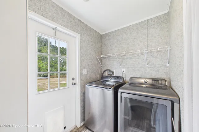 a view of storage and utility room with washer and dryer