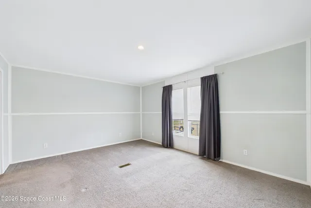 an empty room with a empty space and windows