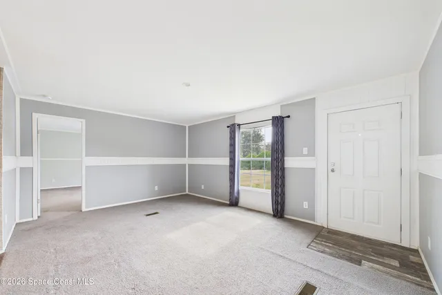 an empty room with a empty space and windows