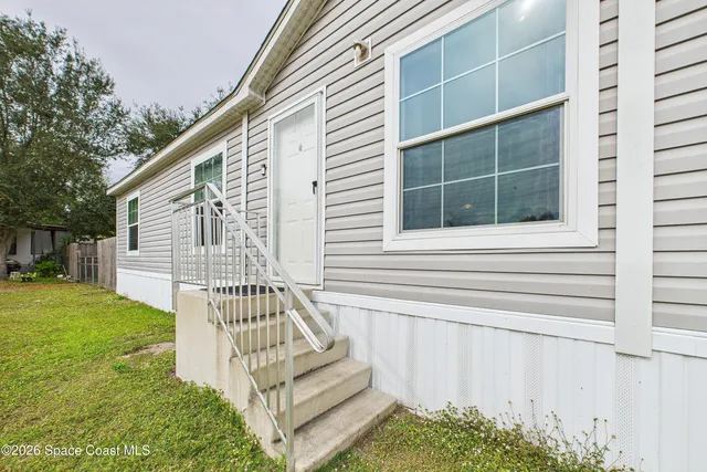 a view of house with backyard and a garden