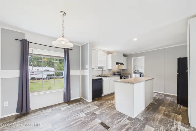 a kitchen with a sink stove and refrigerator