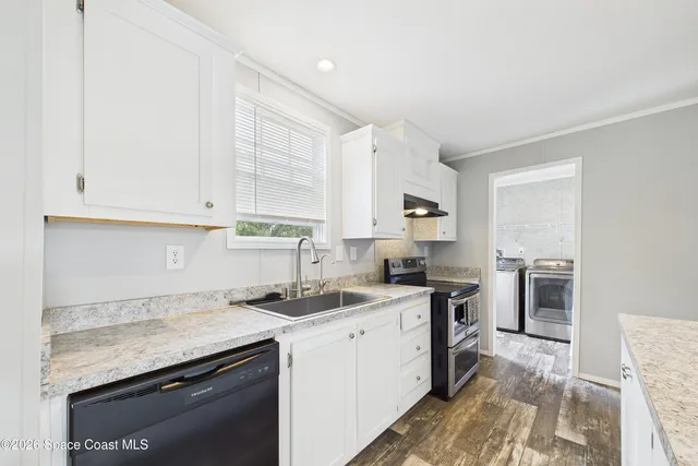 a kitchen with a sink stove and cabinets