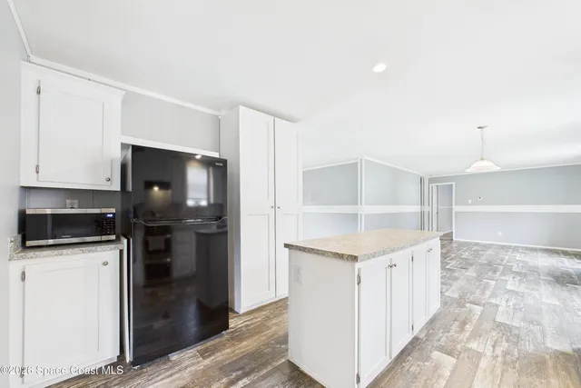 a kitchen with stainless steel appliances a refrigerator sink and cabinets