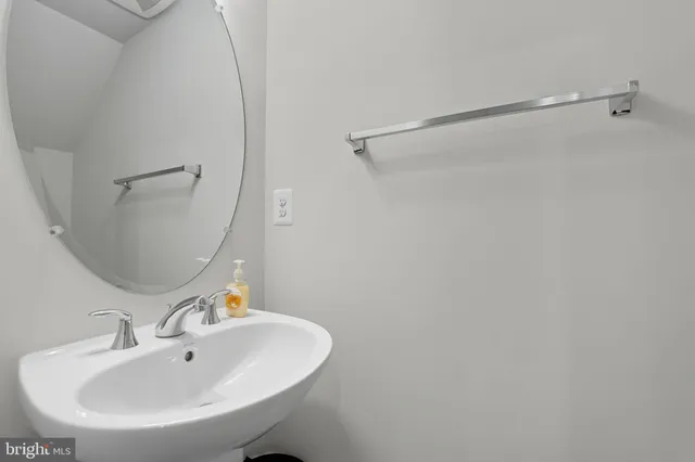a bathroom with a sink and mirror