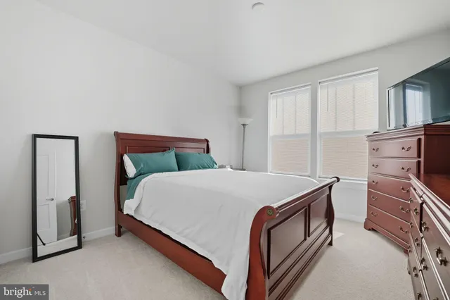 a bed sitting in a bedroom next to a window