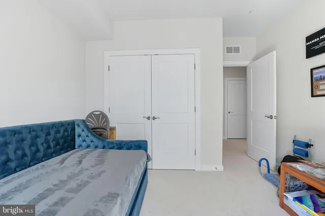 a bedroom with a bed and a closet