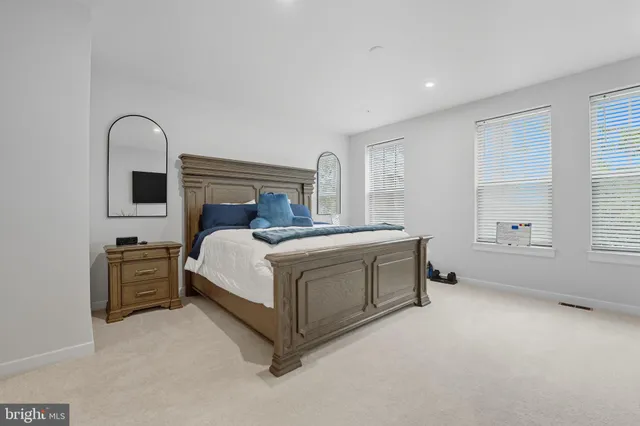 a bed sitting in a room next to a window