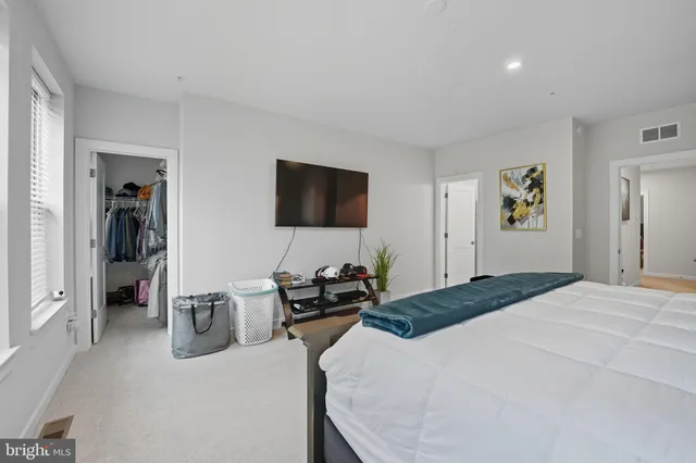 a bedroom with a bed and a television