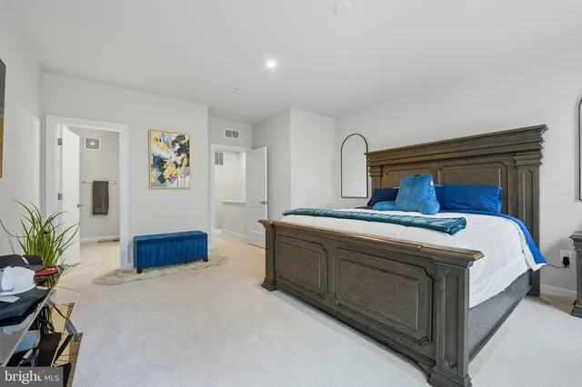 a bedroom with a bed and paintings on the wall