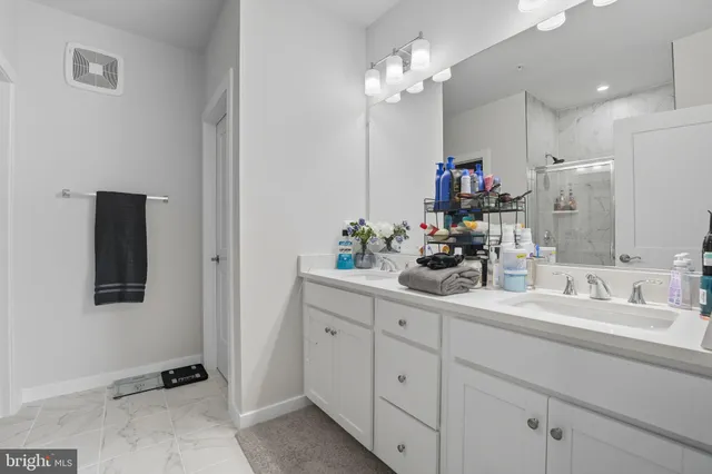 a bathroom with a sink double vanity and a mirror