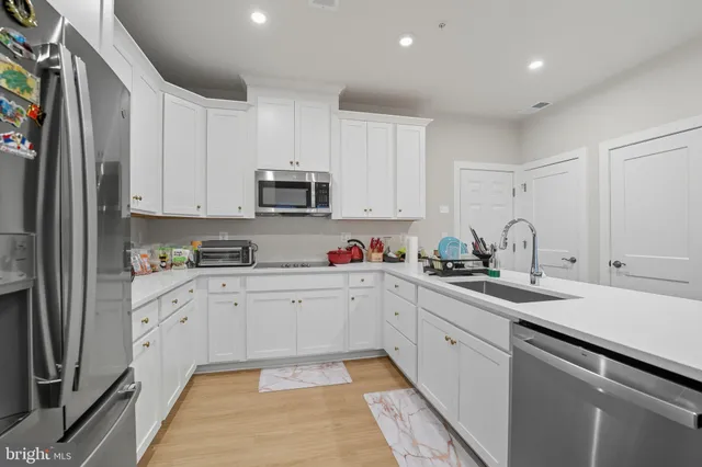 a kitchen with appliances cabinets and a sink